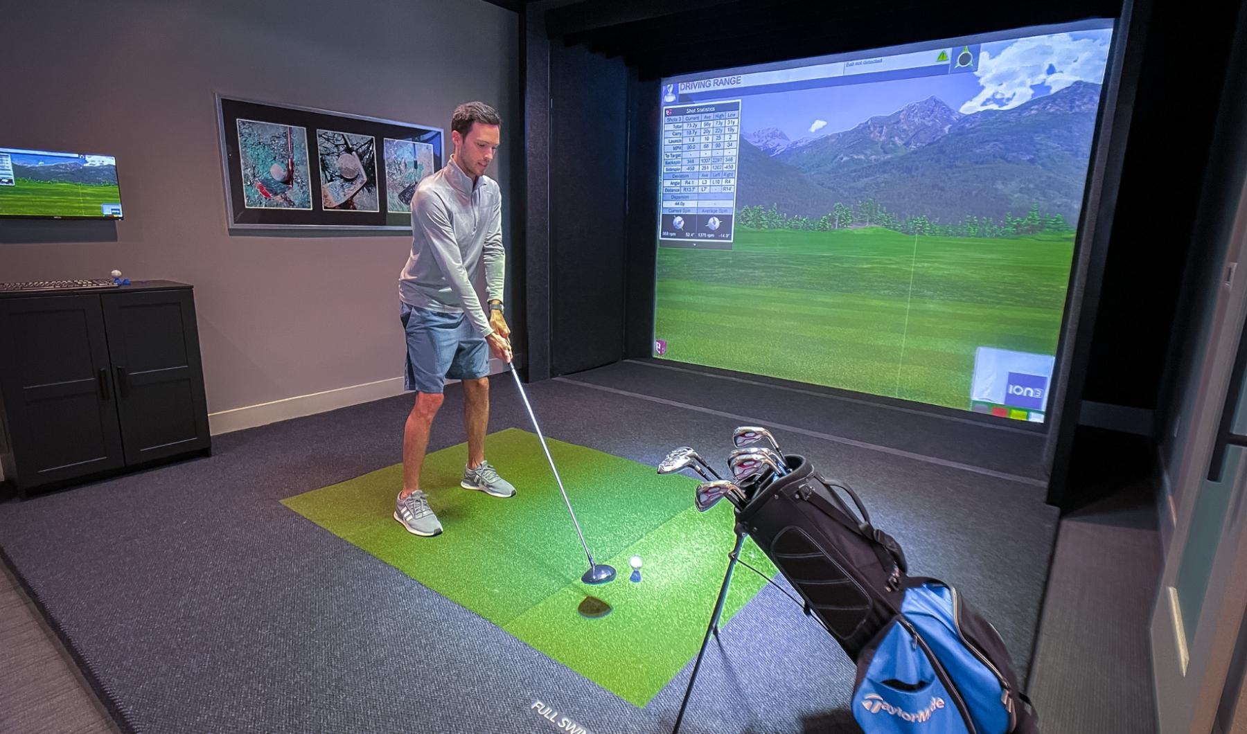 a person playing golf on a simulator